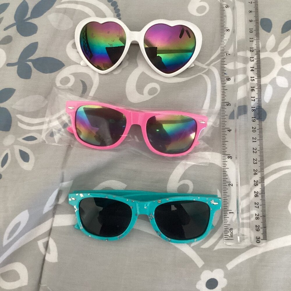 Three pairs of kids sunglasses, heart shaped and squared cat eye